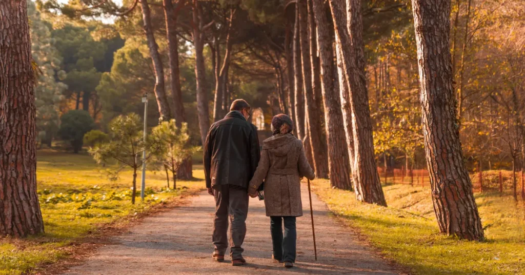 An image of a couple walking through autumn forests- highlighting the blog theme of modern dating guide.
