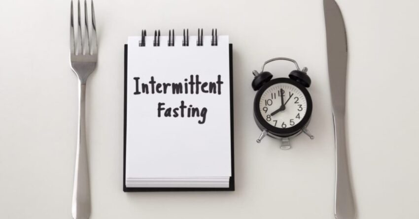 Highliting stainless steel around a small note pad, with intermittent fasting written over it.