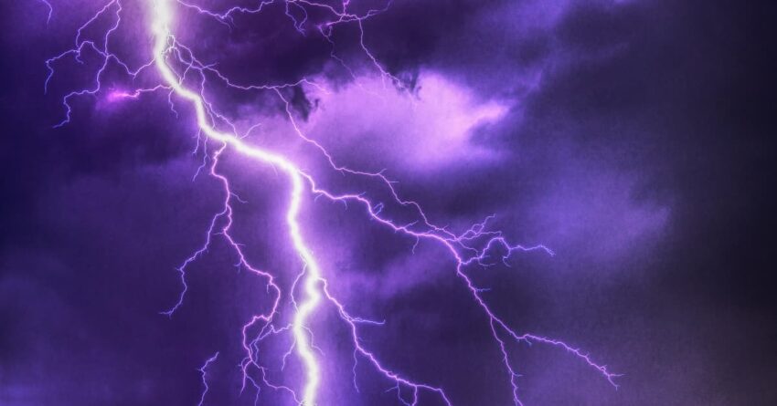 The image shows a severe thunderstorm warning sky, filled with lightning and dark purple clouds.