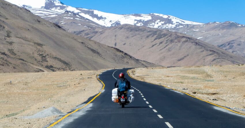 A person driving a bike on a highway on a solo trip.