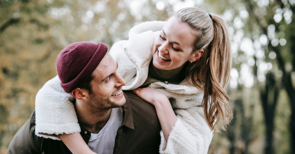 An image of a couple looking at each other like soulmate and smiling.