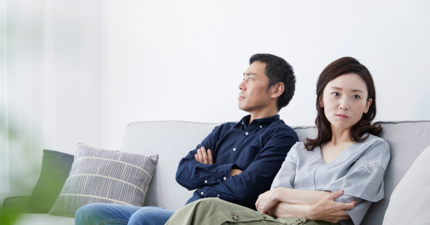 A couple, looking away from one another, after a fight, highlighting possible red flags in relationship.