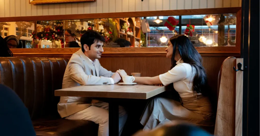 An image of a couple sitting in front of each other and talking, highlighting online dating tips for online dating.