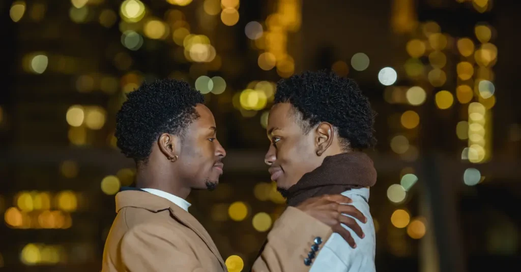 An LGBTQ couple staring at each other lovingly, highlighting chemistry as one of the green flags in a relationship.